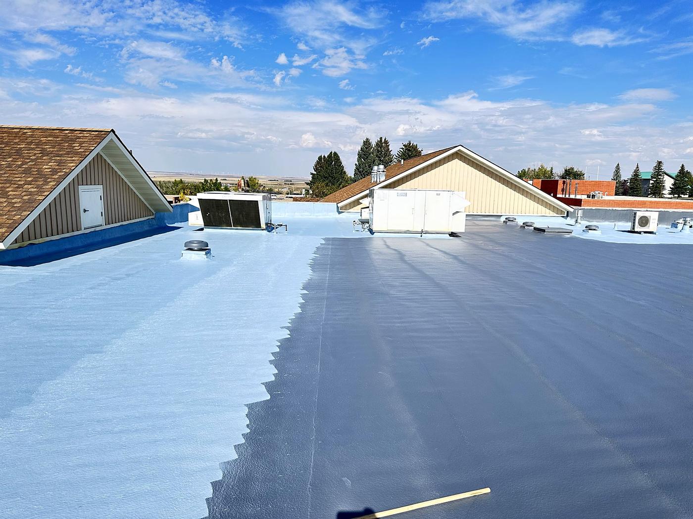 Roof partly coated, showing the old surface next to the new coating