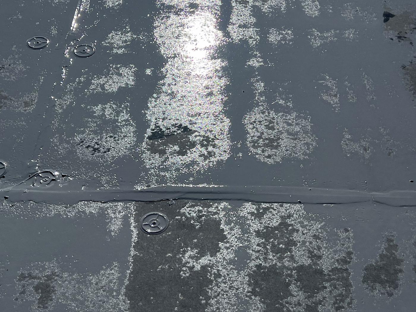 Before: aged roof surface with worn coating and exposed fasteners