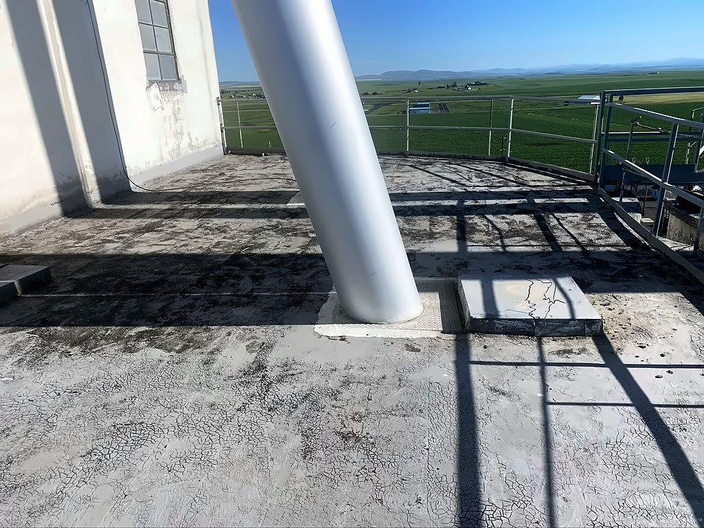Before: weathered concrete roof surface around silo supports