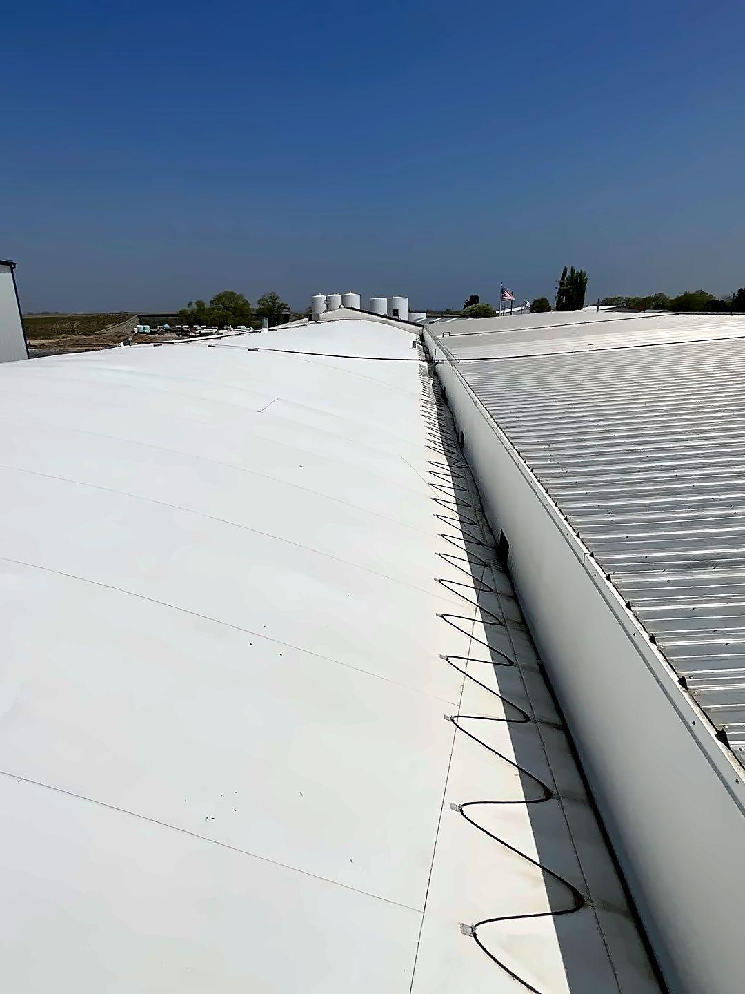 Coated valley running along a metal roof