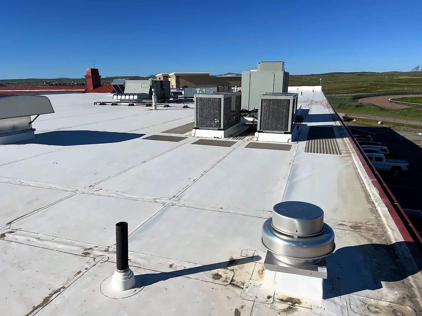 Flat commercial roof with rooftop HVAC units and vents