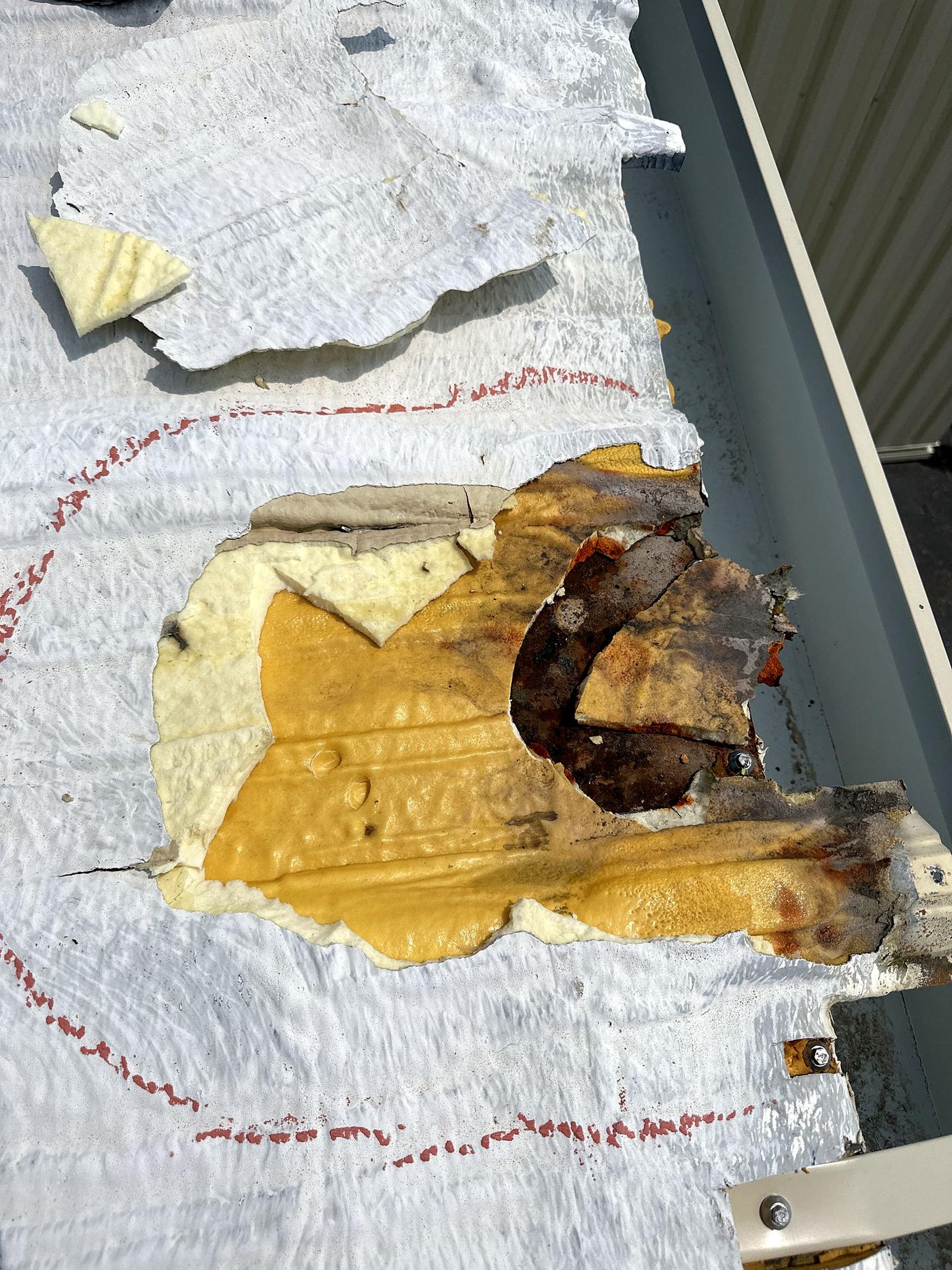 Close-up of a damaged roof area outlined during inspection (Jul 2023)